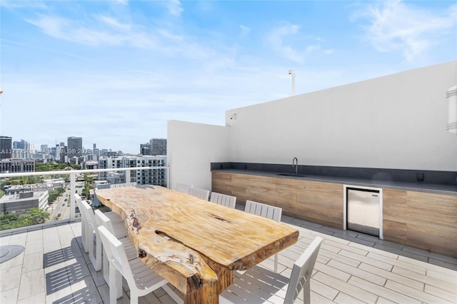 4250 Biscayne Blvd Unit 1112, Miami, FL 33137 - view of patio / terrace with a sink, a skyline view, and outdoor dining space