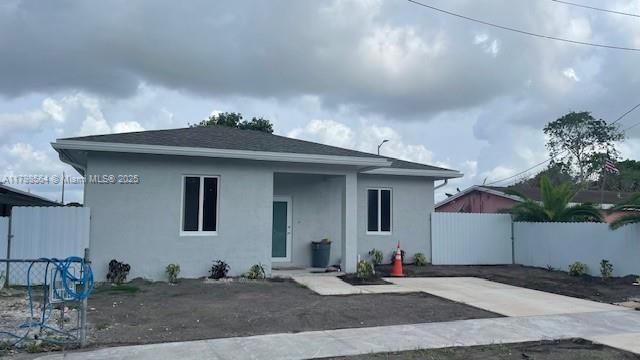 640 SW 12th Ave, Homestead, FL 33030 - view of front of house with a fenced backyard and stucco siding