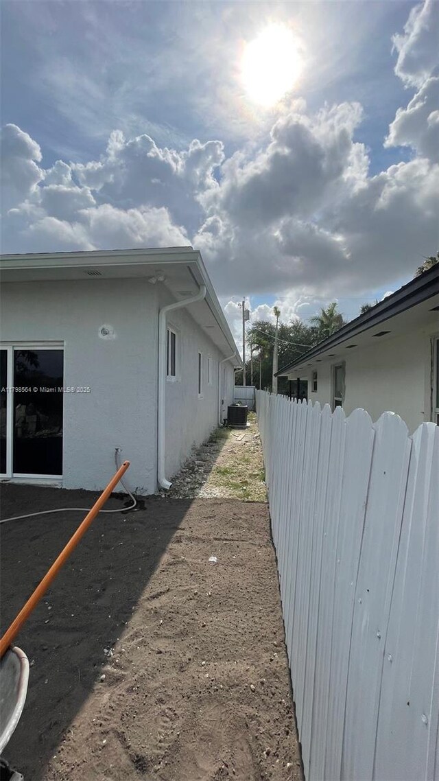 640 SW 12th Ave, Homestead, FL 33030 - view of property exterior featuring stucco siding and a central air condition unit