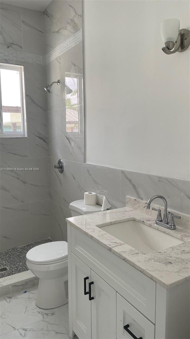 640 SW 12th Ave, Homestead, FL 33030 - full bathroom with vanity, tile walls, a marble finish shower, and marble finish flooring