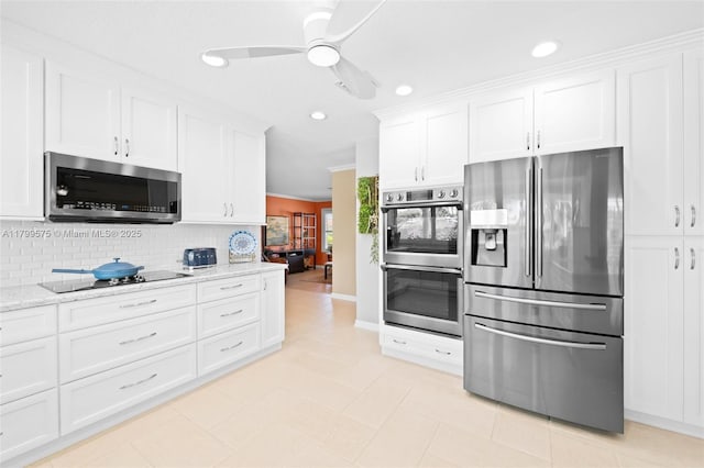 5221 Roosevelt St, Hollywood, FL 33021 - kitchen featuring stainless steel appliances, white cabinets, backsplash, ceiling fan, and recessed lighting