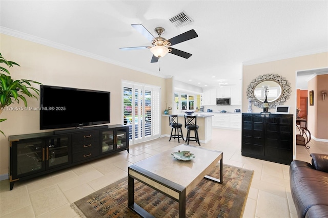 5221 Roosevelt St, Hollywood, FL 33021 - living area with ceiling fan, light tile patterned floors, crown molding, and baseboards