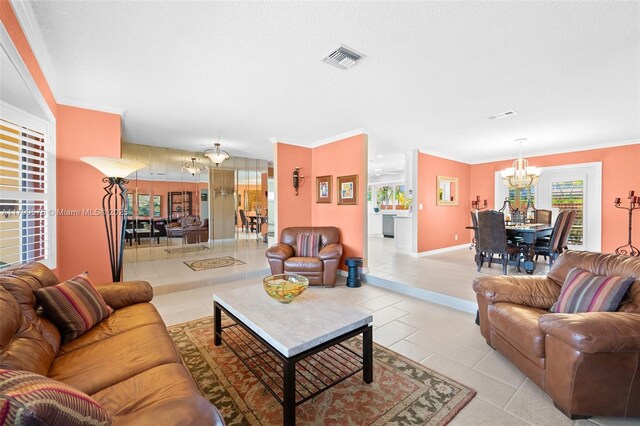 5221 Roosevelt St, Hollywood, FL 33021 - living area with a chandelier, light tile patterned floors, crown molding, and baseboards