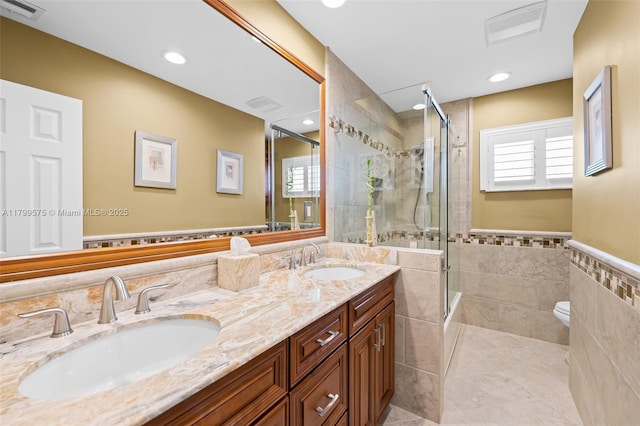 5221 Roosevelt St, Hollywood, FL 33021 - full bath featuring tile walls, tiled shower, double vanity, toilet, and wainscoting