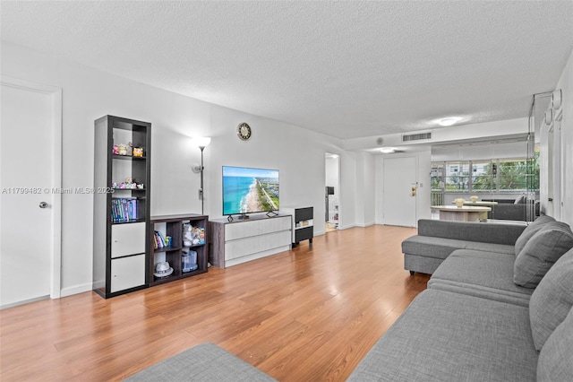 251 174th St Unit 212, Sunny Isles Beach, FL 33160 - living area featuring light wood finished floors and a textured ceiling
