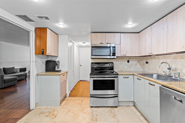 251 174th St Unit 212, Sunny Isles Beach, FL 33160 - kitchen with appliances with stainless steel finishes, a sink, and backsplash