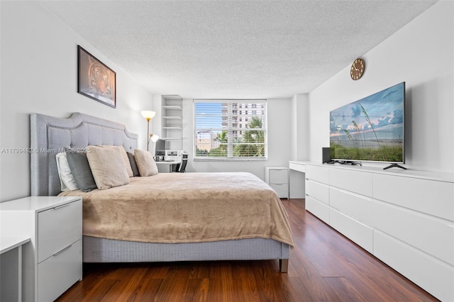 251 174th St Unit 212, Sunny Isles Beach, FL 33160 - bedroom featuring a textured ceiling and dark wood-type flooring