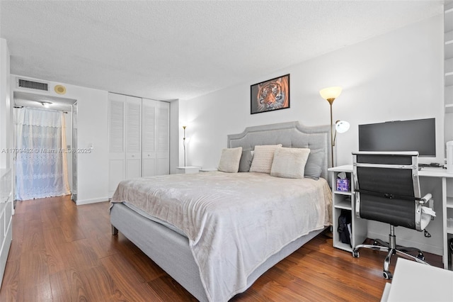 251 174th St Unit 212, Sunny Isles Beach, FL 33160 - bedroom with wood finished floors, a textured ceiling, and a closet