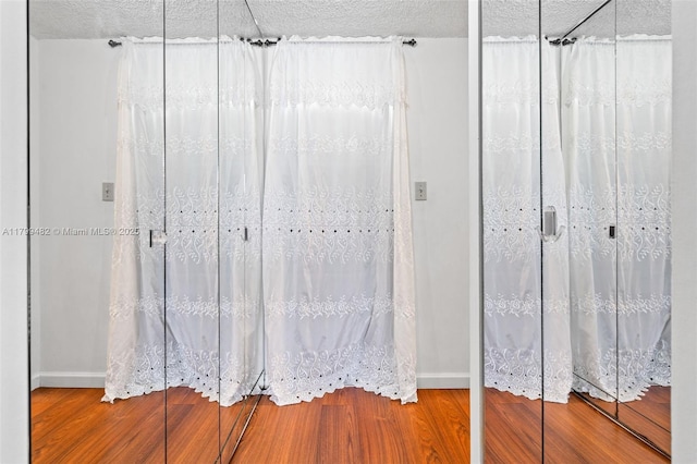 251 174th St Unit 212, Sunny Isles Beach, FL 33160 - bathroom with wood finished floors, baseboards, and a textured ceiling