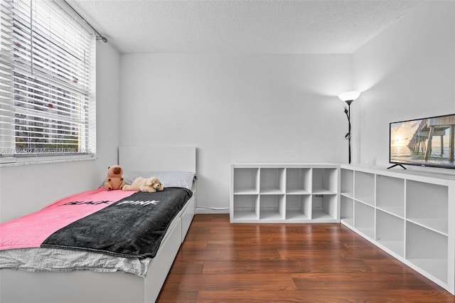 251 174th St Unit 212, Sunny Isles Beach, FL 33160 - bedroom with wood finished floors and a textured ceiling