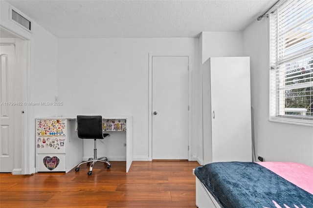 251 174th St Unit 212, Sunny Isles Beach, FL 33160 - bedroom with wood finished floors and a textured ceiling