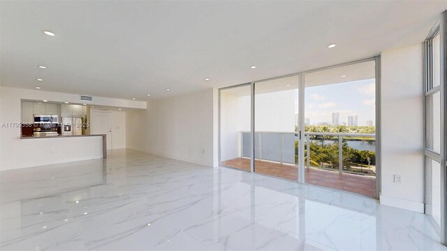 3625 N Country Club Dr Unit 609, Aventura, FL 33180 - unfurnished living room featuring floor to ceiling windows, light marble finish flooring, and recessed lighting