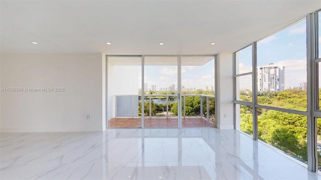 3625 N Country Club Dr Unit 609, Aventura, FL 33180 - spare room featuring expansive windows, a view of city, marble tiled flooring, and recessed lighting