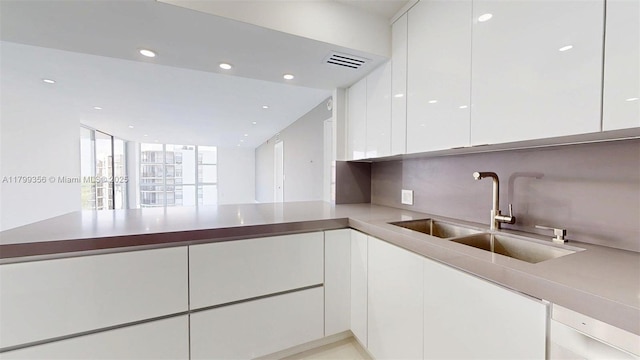 3625 N Country Club Dr Unit 609, Aventura, FL 33180 - kitchen with a sink, white cabinetry, modern cabinets, recessed lighting, and light countertops