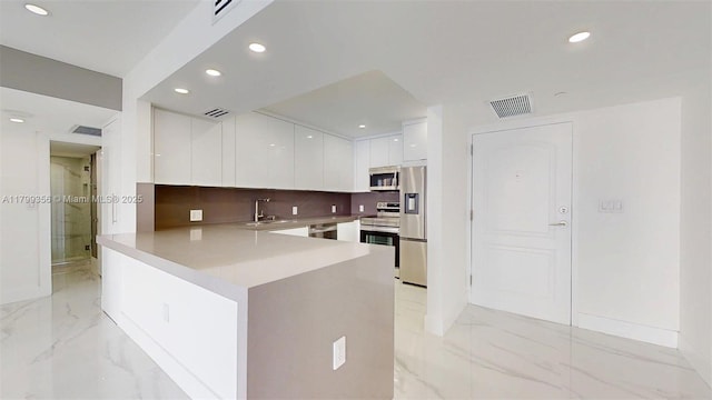 3625 N Country Club Dr Unit 609, Aventura, FL 33180 - kitchen with modern cabinets, stainless steel appliances, a peninsula, white cabinetry, and light marble finish floors