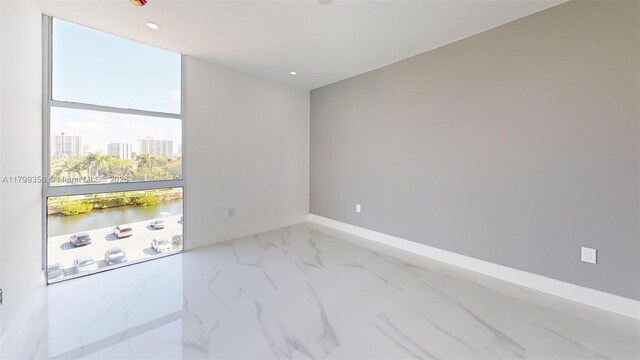 3625 N Country Club Dr Unit 609, Aventura, FL 33180 - spare room with marble finish floors, a water view, a view of city, baseboards, and recessed lighting