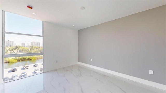 3625 N Country Club Dr Unit 609, Aventura, FL 33180 - spare room with a water view, marble finish flooring, baseboards, a city view, and recessed lighting