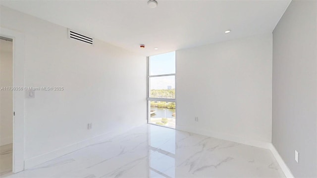 3625 N Country Club Dr Unit 609, Aventura, FL 33180 - spare room with marble finish flooring, baseboards, floor to ceiling windows, and recessed lighting