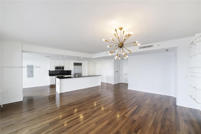 901 Brickell Key Blvd Unit 607, Miami, FL 33131 - unfurnished living room featuring a chandelier, dark wood-type flooring, a sink, recessed lighting, and electric panel