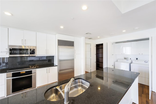 901 Brickell Key Blvd Unit 607, Miami, FL 33131 - kitchen with stainless steel appliances, independent washer and dryer, a sink, white cabinetry, and recessed lighting