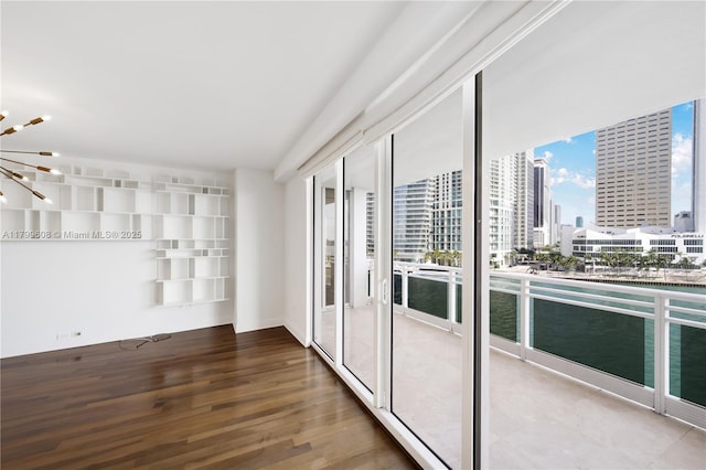 901 Brickell Key Blvd Unit 607, Miami, FL 33131 - empty room with wood finished floors, a view of city, and a water view