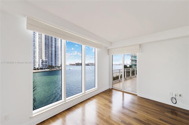 901 Brickell Key Blvd Unit 607, Miami, FL 33131 - unfurnished room featuring wood finished floors, a water view, and baseboards