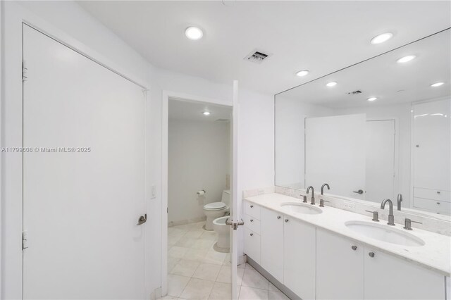 901 Brickell Key Blvd Unit 607, Miami, FL 33131 - full bath with recessed lighting, toilet, double vanity, a bidet, and tile patterned floors