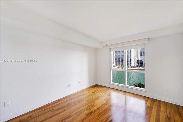 901 Brickell Key Blvd Unit 607, Miami, FL 33131 - empty room with baseboards and wood finished floors