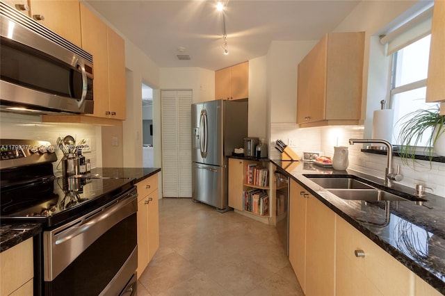 246 NE 92nd St, Miami Shores, FL 33138 - kitchen with stainless steel appliances, a sink, decorative backsplash, and dark stone counters