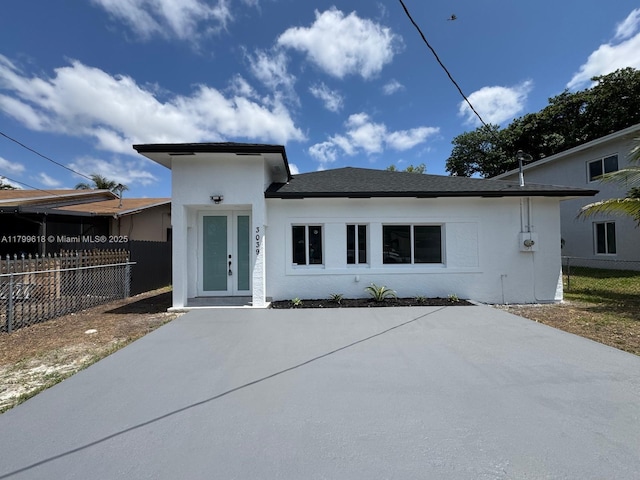 3039 NW 51st Ter, Miami, FL 33142 - view of front of home with stucco siding, fence, and a patio