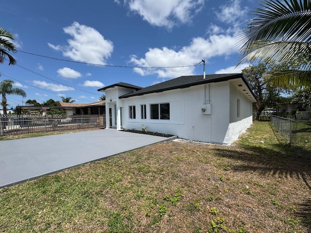 3039 NW 51st Ter, Miami, FL 33142 - back of property featuring stucco siding and a patio