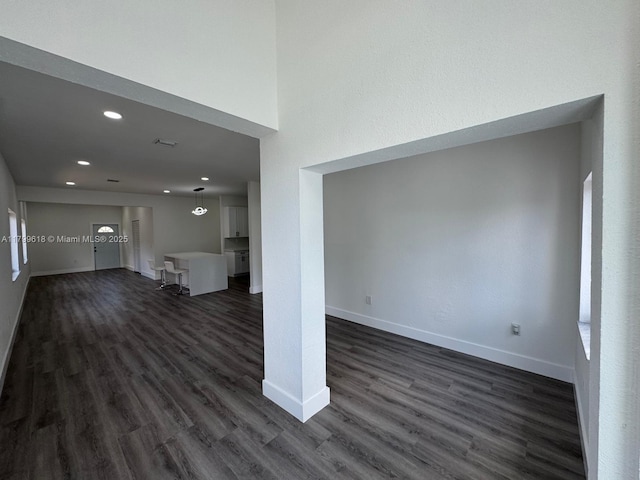 3039 NW 51st Ter, Miami, FL 33142 - unfurnished living room with dark wood-type flooring, recessed lighting, and baseboards