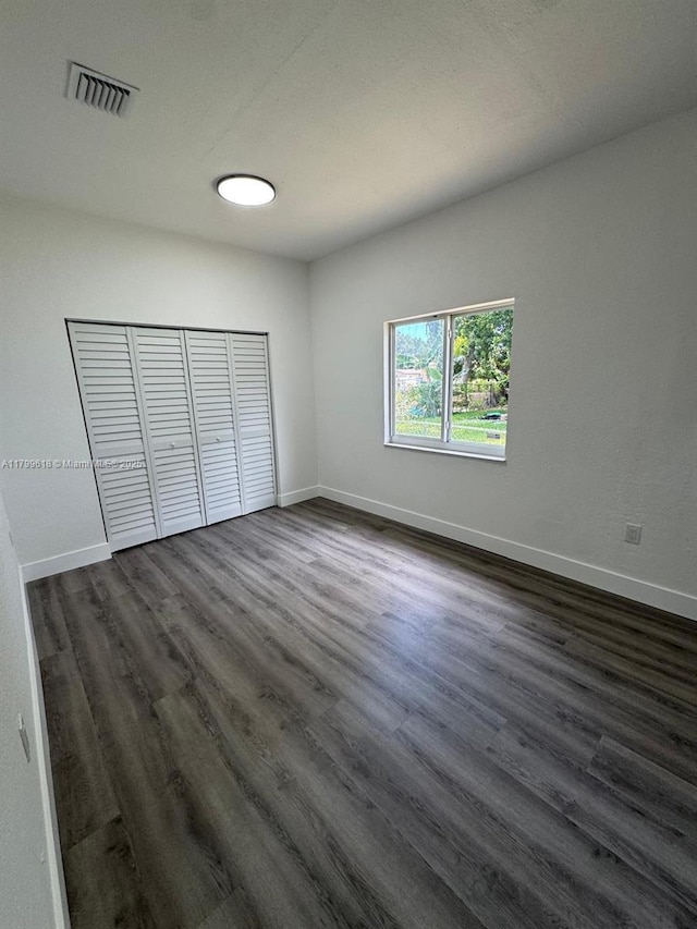 3039 NW 51st Ter, Miami, FL 33142 - spare room featuring dark wood-style flooring and baseboards