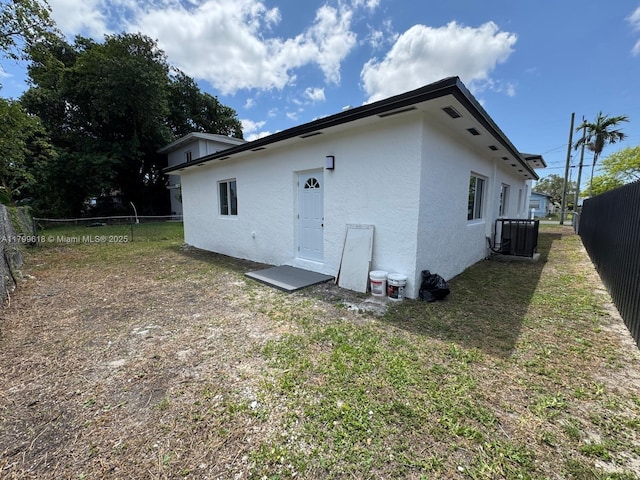 3039 NW 51st Ter, Miami, FL 33142 - back of property featuring stucco siding and central AC unit