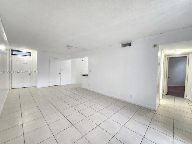 216 Lake Pointe Dr Unit 128, Oakland Park, FL 33309 - spare room with light tile patterned flooring and baseboards