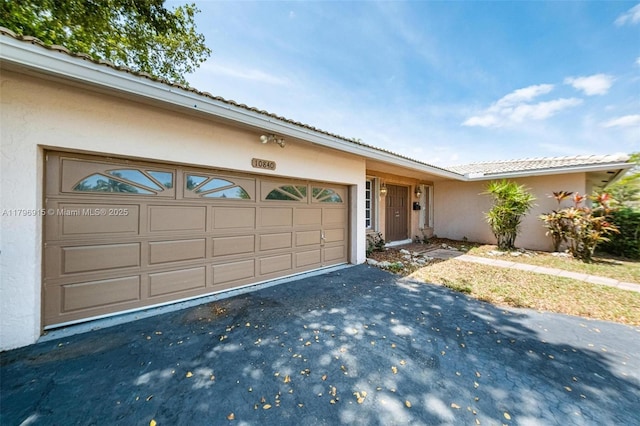 10840 NW 40th St, Coral Springs, FL 33065 - view of front of home featuring stucco siding, driveway, an attached garage, and a tile roof