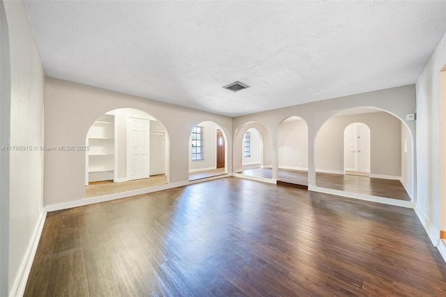 10840 NW 40th St, Coral Springs, FL 33065 - unfurnished living room with wood finished floors, baseboards, and a textured ceiling