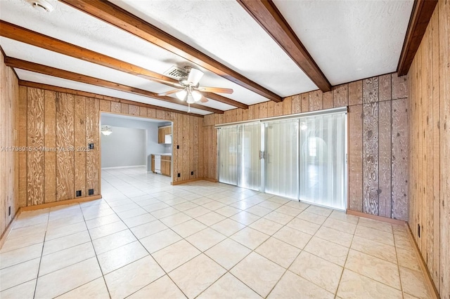 10840 NW 40th St, Coral Springs, FL 33065 - spare room featuring wooden walls, beamed ceiling, ceiling fan, light tile patterned floors, and a textured ceiling