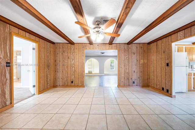 10840 NW 40th St, Coral Springs, FL 33065 - spare room featuring beam ceiling, a ceiling fan, light tile patterned floors, wood walls, and baseboards