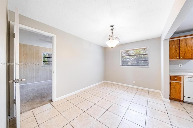 10840 NW 40th St, Coral Springs, FL 33065 - unfurnished dining area featuring plenty of natural light, light tile patterned flooring, and baseboards