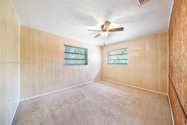 10840 NW 40th St, Coral Springs, FL 33065 - carpeted empty room featuring a ceiling fan, a textured ceiling, and wood walls