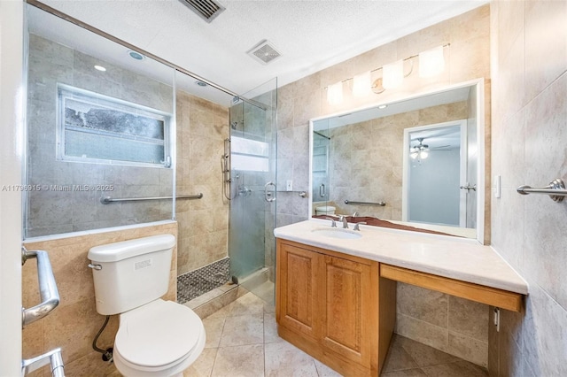 10840 NW 40th St, Coral Springs, FL 33065 - full bathroom with toilet, a shower stall, tile walls, vanity, and tile patterned floors