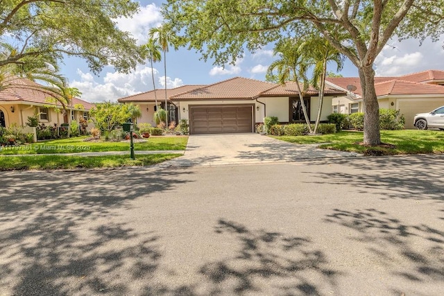 808 Hampton Ct, Weston, FL 33326 - view of front of house featuring an attached garage, a tiled roof, stucco siding, concrete driveway, and a front lawn