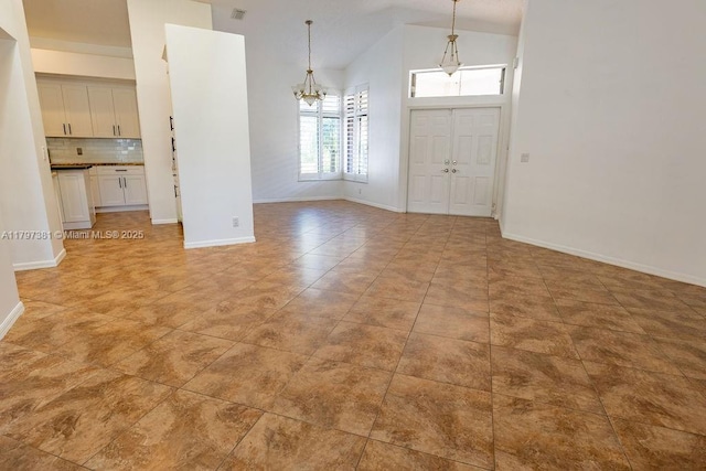 808 Hampton Ct, Weston, FL 33326 - unfurnished dining area with a chandelier, high vaulted ceiling, baseboards, and light tile patterned flooring