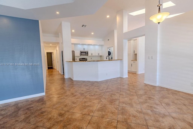 808 Hampton Ct, Weston, FL 33326 - unfurnished living room with high vaulted ceiling, light tile patterned floors, baseboards, and recessed lighting