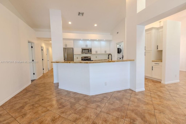 808 Hampton Ct, Weston, FL 33326 - kitchen featuring stainless steel appliances, white cabinets, light stone countertops, light tile patterned floors, and recessed lighting