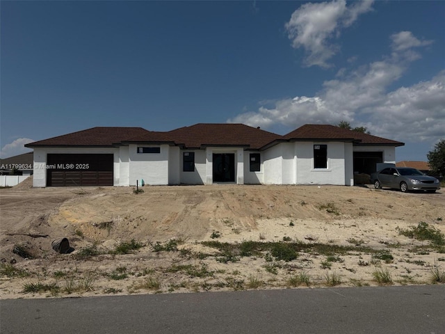 1729 NW 9th St, Cape Coral, FL 33993 - view of front facade featuring a garage and stucco siding
