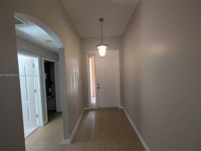 2013 NE 3rd Ct, Homestead, FL 33033 - entrance foyer featuring arched walkways, light tile patterned flooring, and baseboards