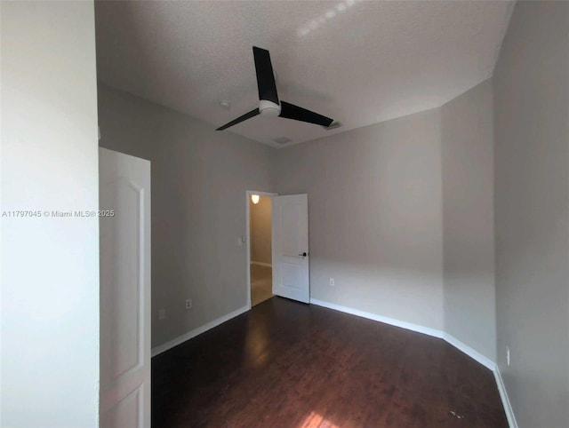 2013 NE 3rd Ct, Homestead, FL 33033 - unfurnished bedroom with dark wood-style flooring, baseboards, ceiling fan, and a textured ceiling