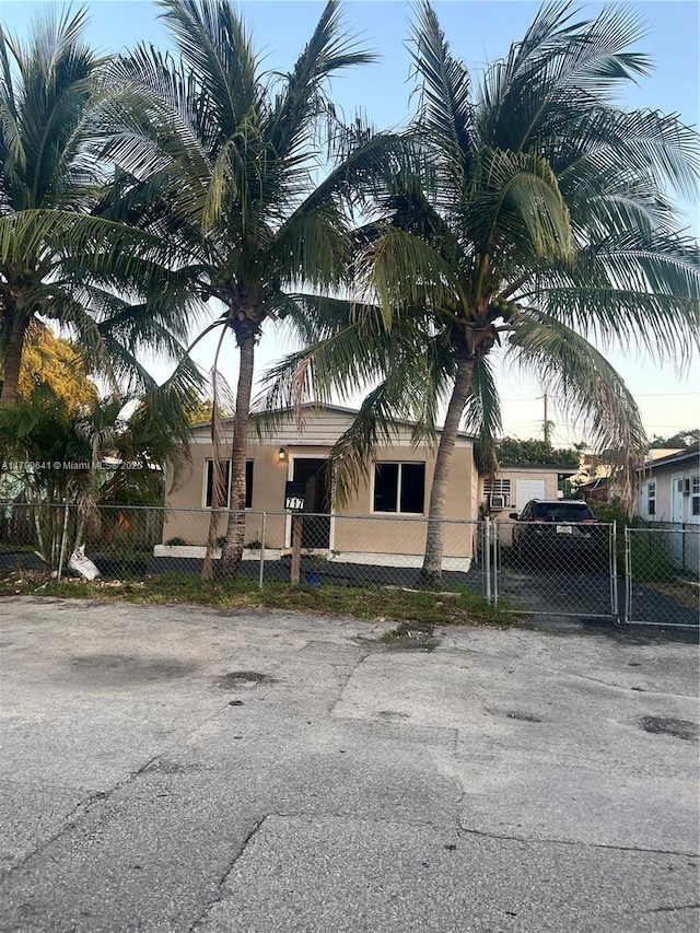 717 NW 1st St, Hallandale Beach, FL 33009 - view of front of property featuring a gate, stucco siding, and a fenced front yard